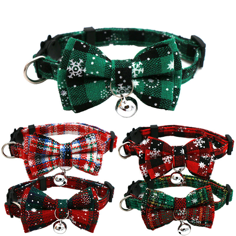 Five Christmas cat collars with snowflake bow ties and bells in dark green, red tartan, red and black check, black and red sparkle, and green and red designs