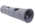 Long grey suede-touch cat tunnel with peek holes and a hanging pom-pom toy inside