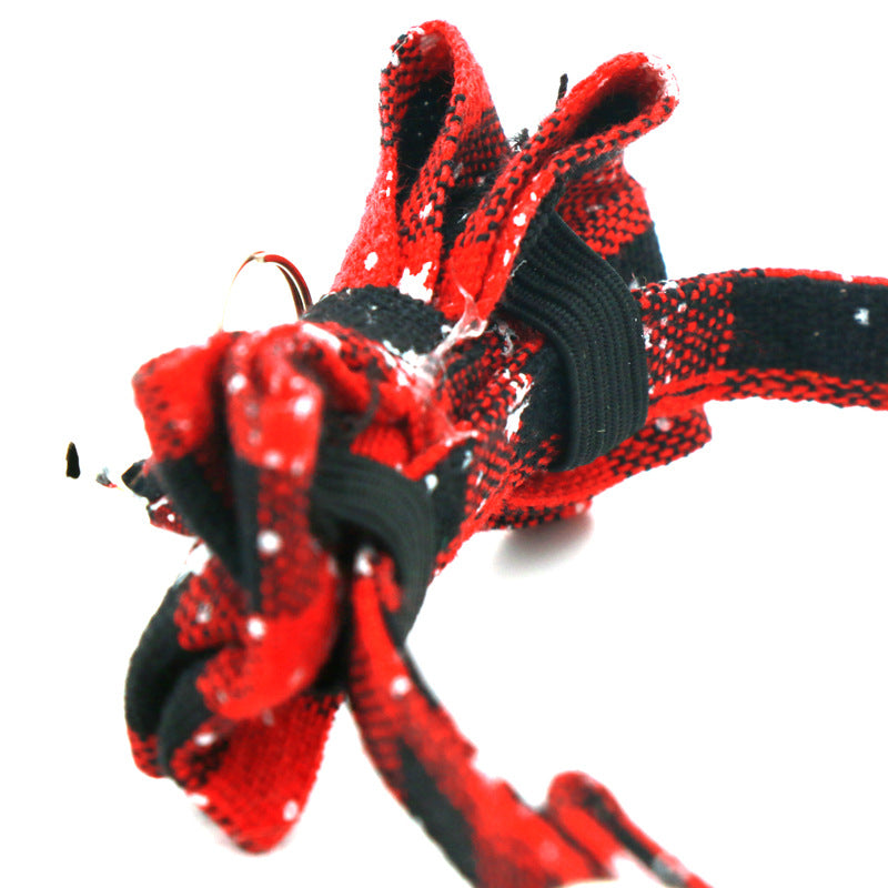 Close-up of a red and black snowflake bow tie on a Christmas cat collar