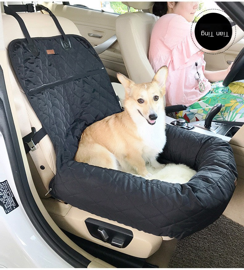 Corgi sitting in a black quilted pet car bed on the front seat – TailoraStyle