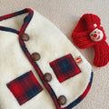 White fleece Christmas dog vest coat with red plaid pockets and a red knitted Santa scarf